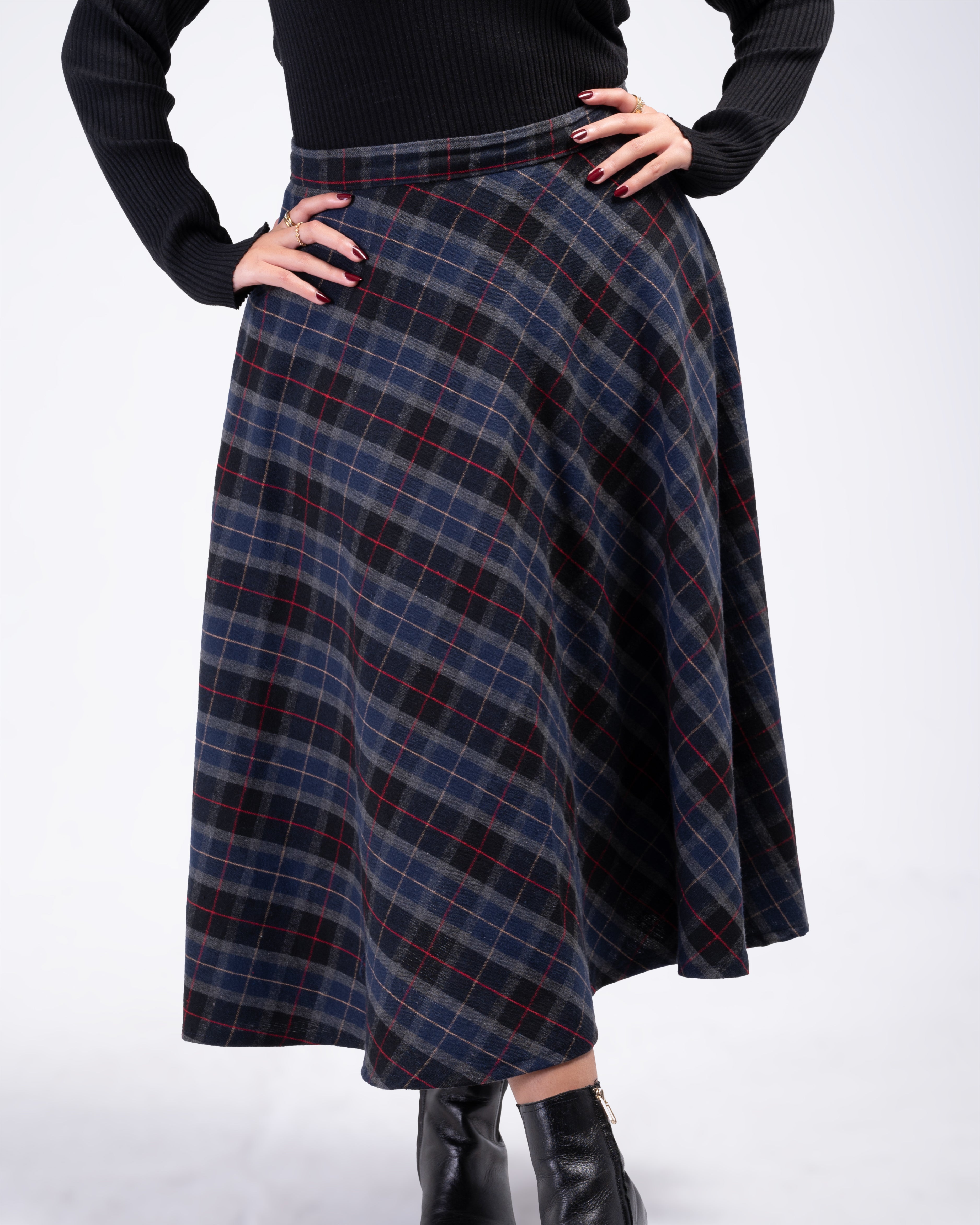 Plaid skirt worn by a person on a white background
